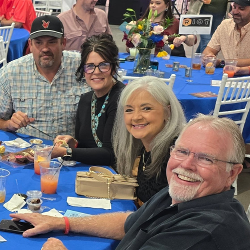 Community members smiling at Taste of Milam, an event benefiting CASA of Milam County.