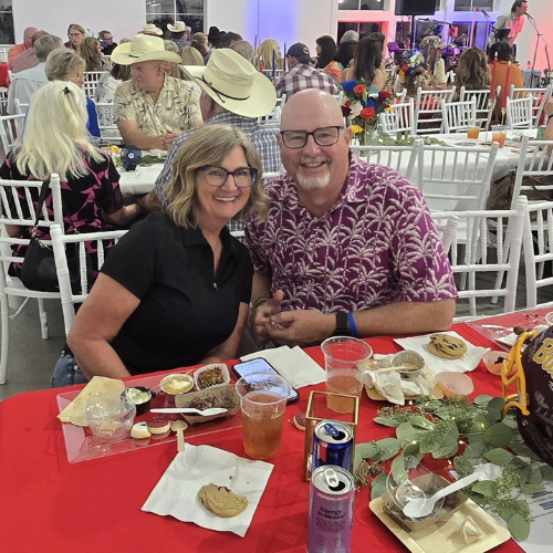 Guests smiling at a table during the Taste of Milam community fundraiser benefiting CASA of Milam County.